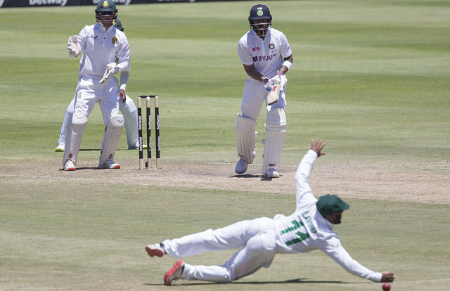 Indian captain Virat Kohli watches as South African fielder Temba Bavuma narrowly misses the ball during the third day of the third and final test match between South Africa and India in Cape Town, South Africa, Thursday, Jan. 13, 2022. (AP Photo/Halden Krog)